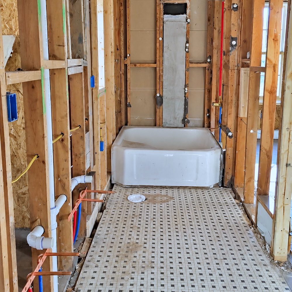 Bathroom rough-in with PEX and copper stub-outs in open wall framing
